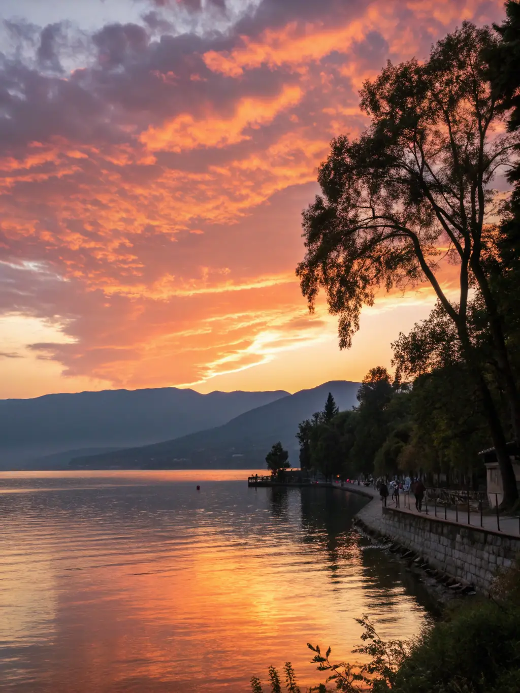 A picturesque scene of a sunset over Mont Passot, with silhouetted trees and vibrant colors reflecting in the surrounding lakes, capturing the essence of the sunset tour.